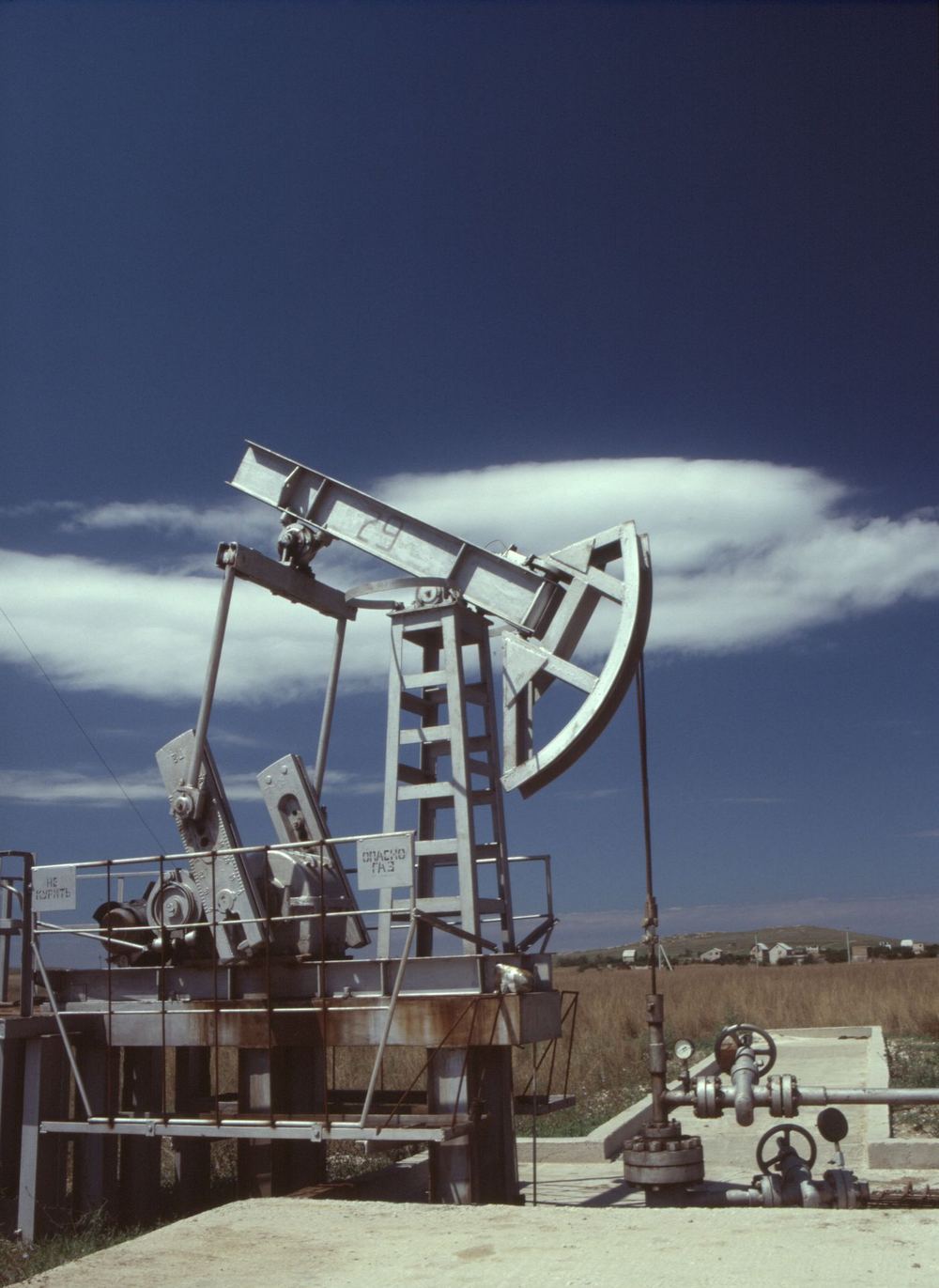Pump jack on an oil and gas lease at dusk