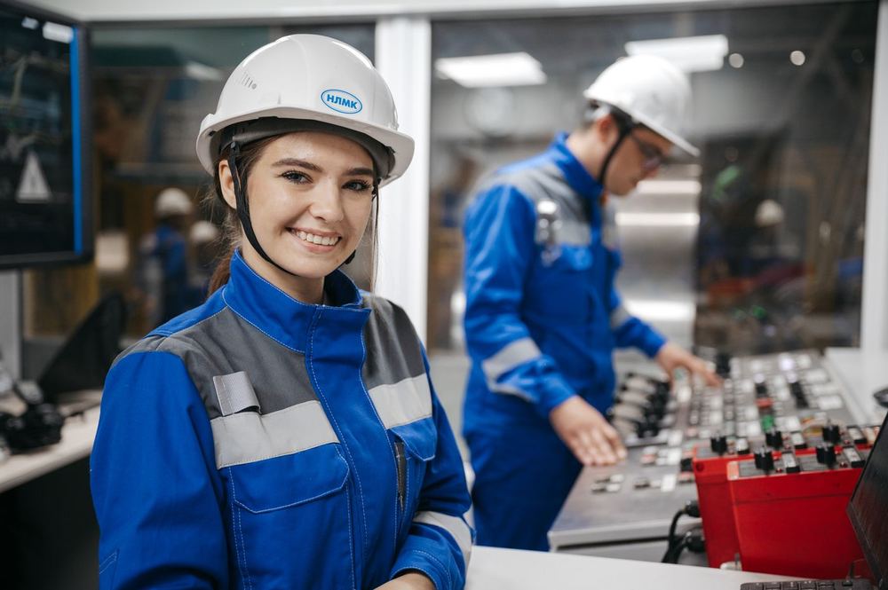 Two operators working at a plant control panel