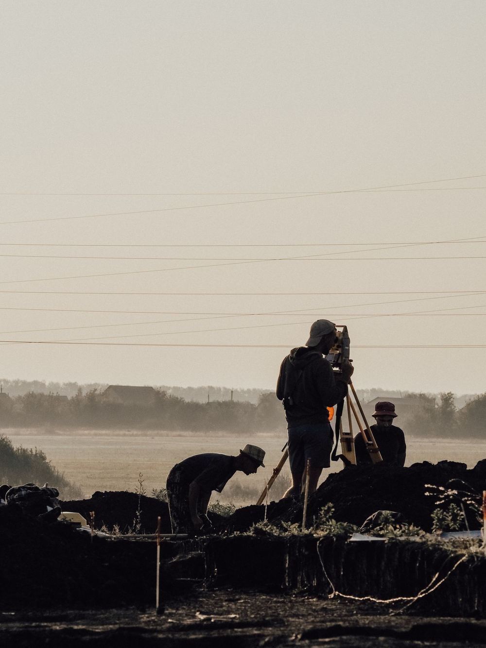 Survey crew working in the field at dusk