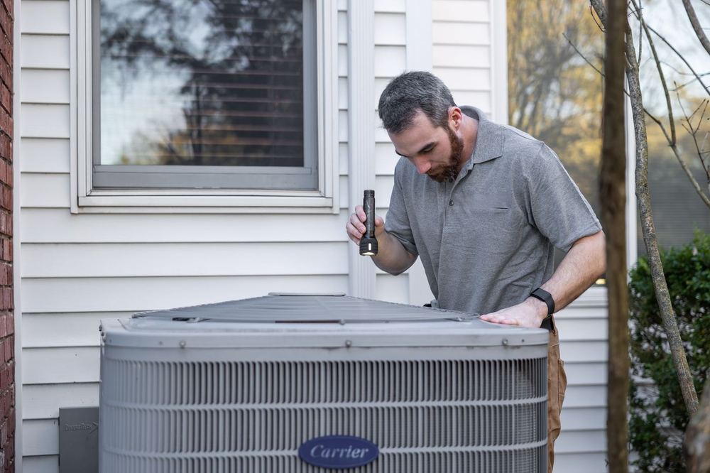 Service technician working on a residential air conditioning unit